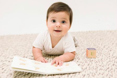 8, 9, 10 month old playing on the floor with a book and a block, 8-10 month sleep regression