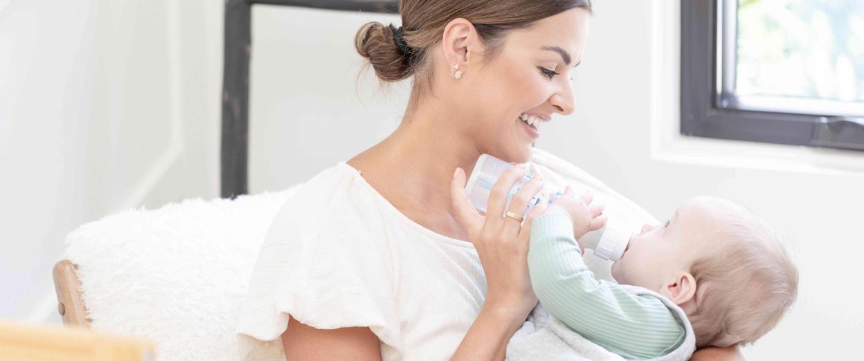 mom feeding baby bottle