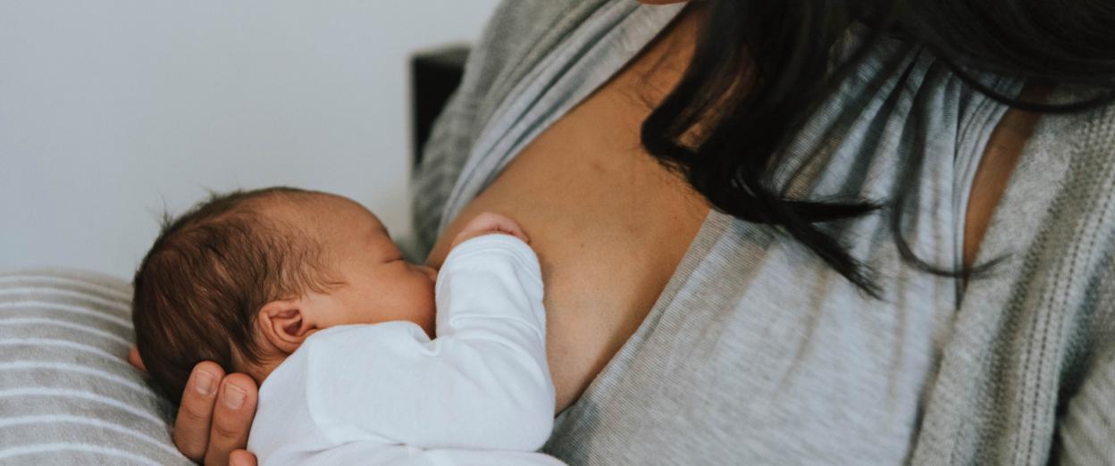new mom breastfeeding newborn baby