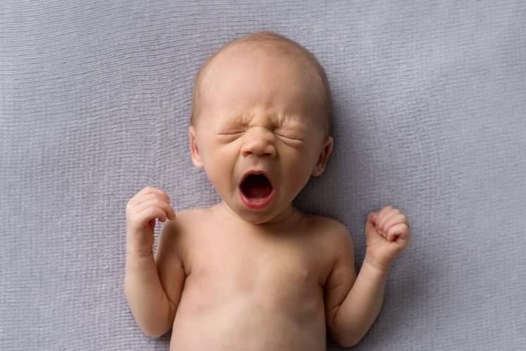 baby yawning after being up all night with day-night confusion