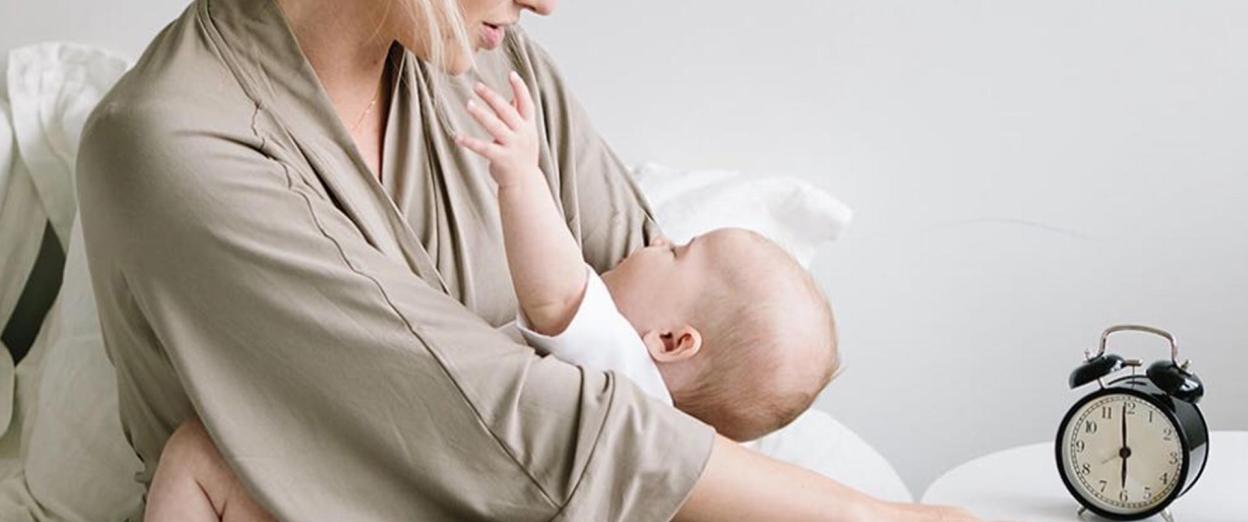 mom looking at baby wondering why she is up so early after daylight savings