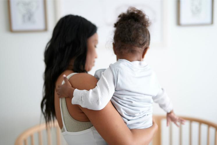 Mom dressing baby for sleep