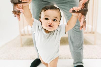 baby walking with Dad during awake time between naps