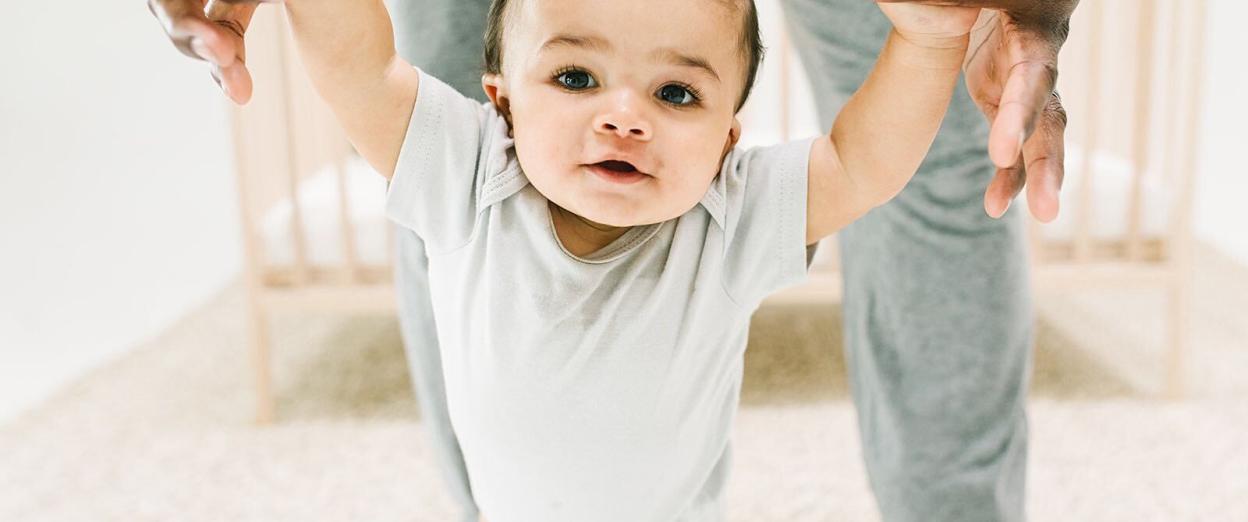 baby walking with Dad during awake time between naps