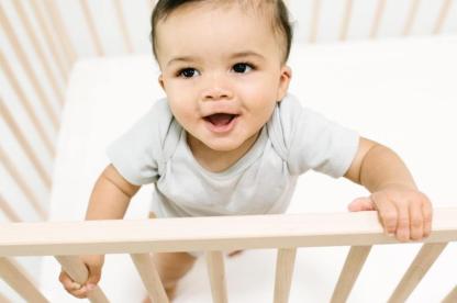 baby standing in crib for safe sleep