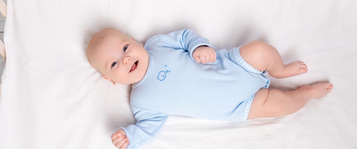 baby laying happily in crib since he is ready to drop a nap