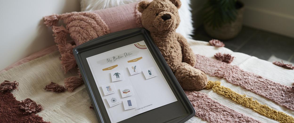 magnetic bedtime routine chart on bed with teddy bear